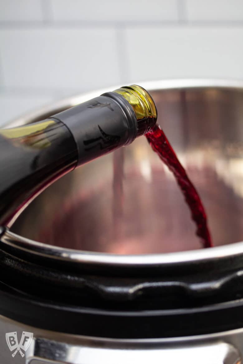 Pouring red wine into an Instant Pot.