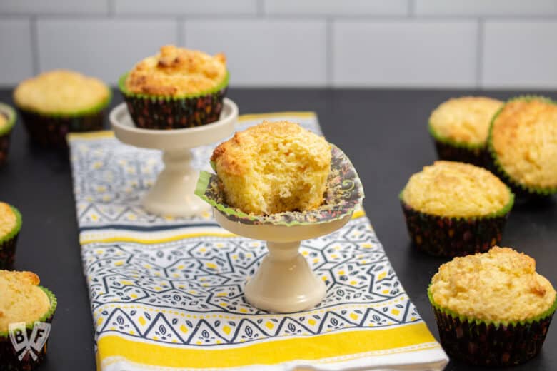 Sweet corn muffin with a bite taken out of it surrounded by more muffins.