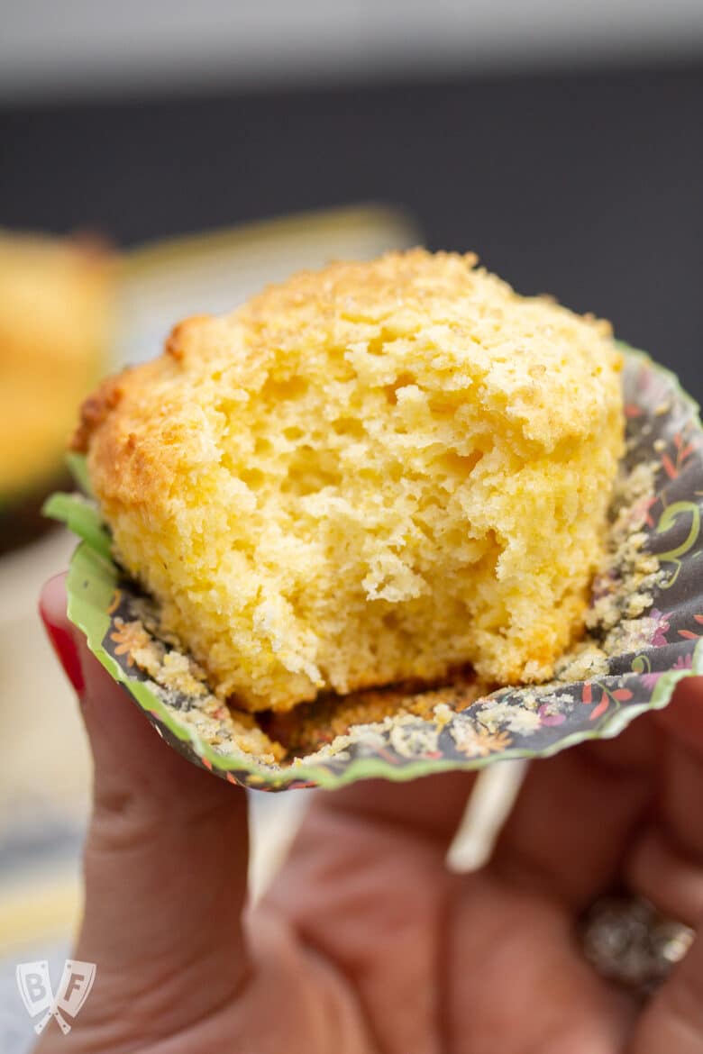 Close-up of a sweet corn muffin with a bite taken out.