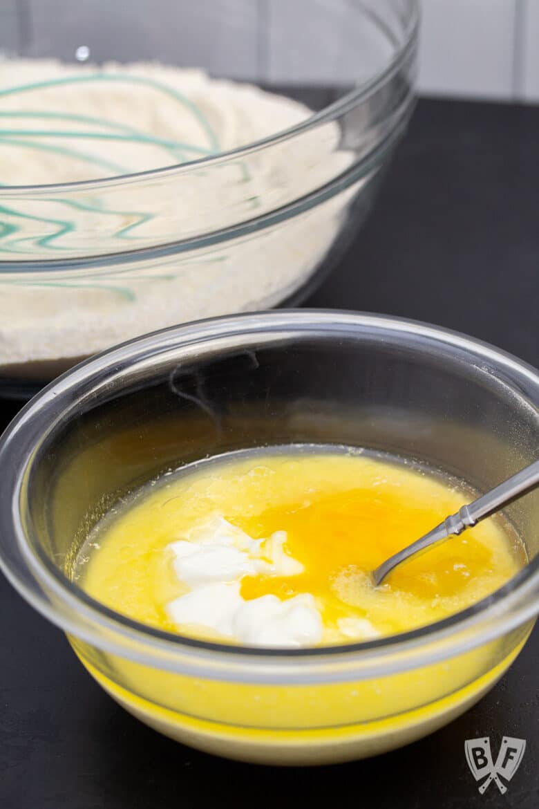 Bowls of wet and dry ingredients for sweet corn muffin recipe.