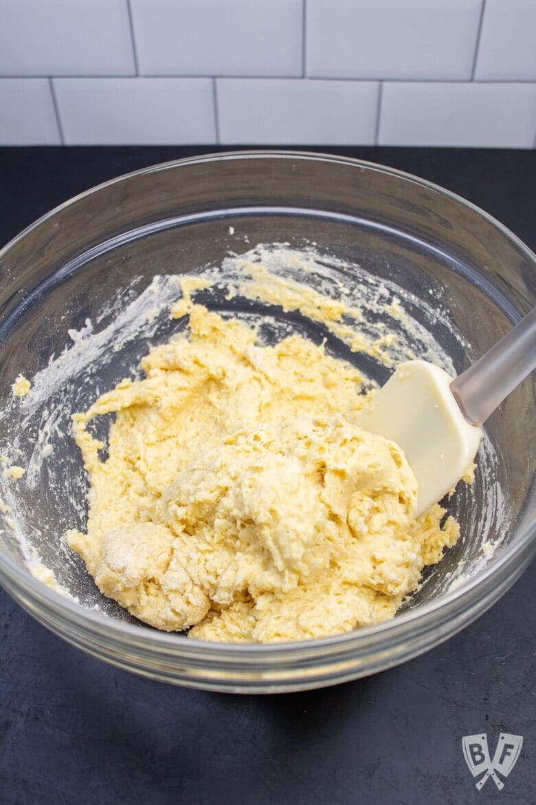 Bowl of sweet corn muffin batter with a spatula.