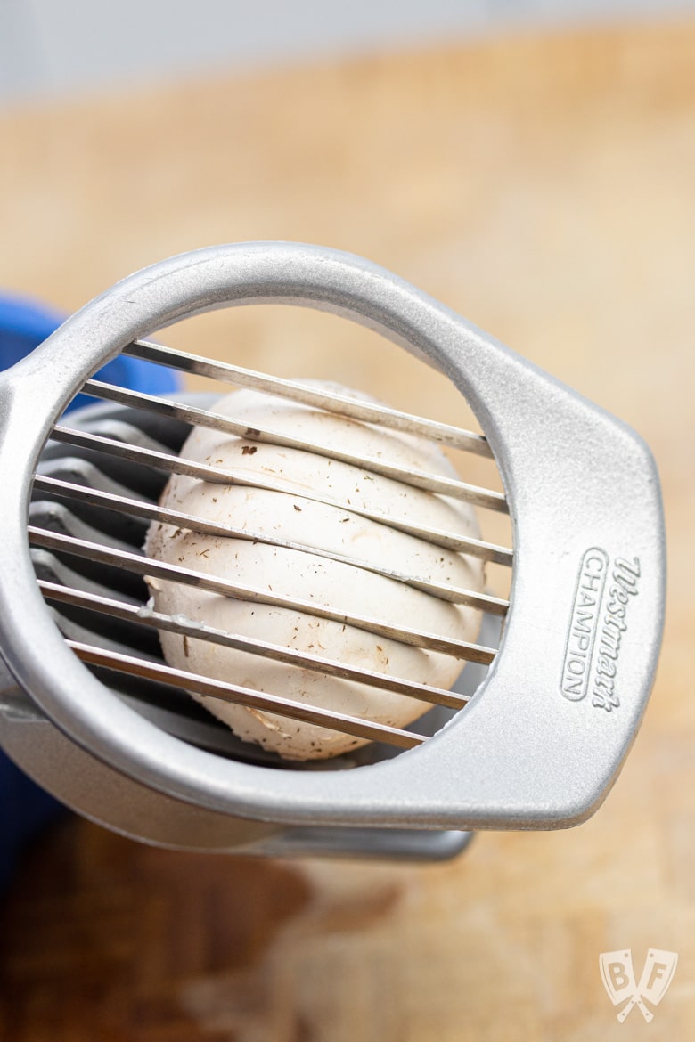 Cutting a mushroom with an egg slicer.