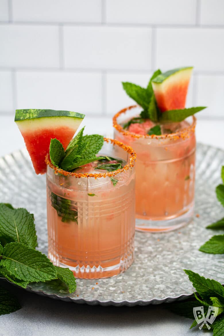 2 cocktails garnished with watermelon and fresh mint.