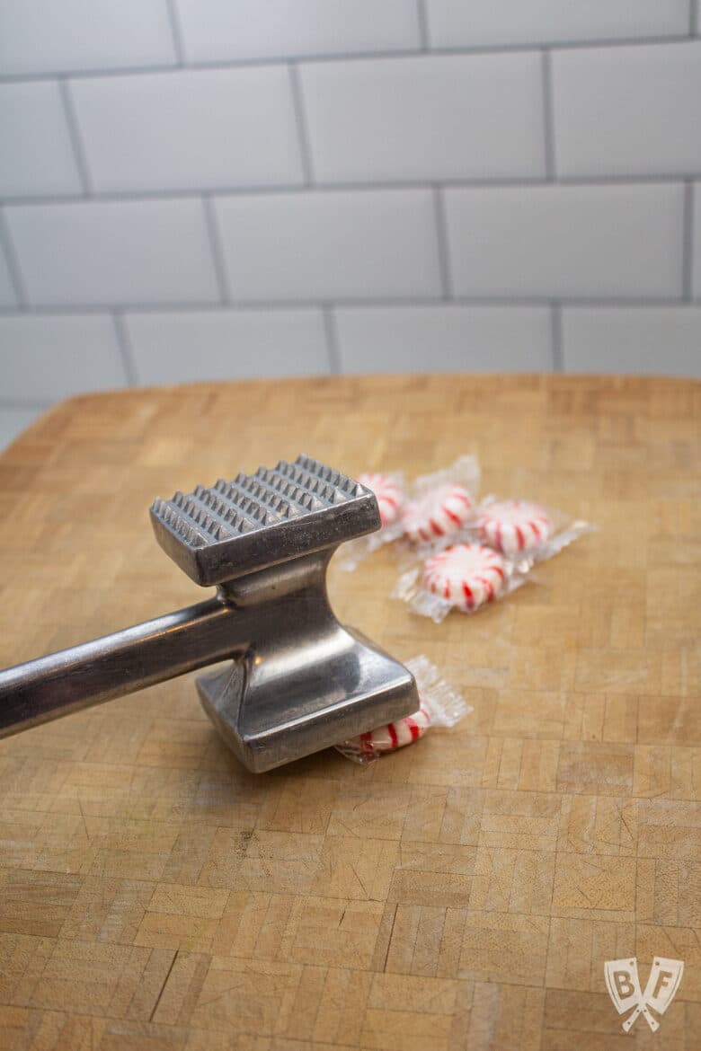 Smashing a peppermint candy with a meat tenderizer.