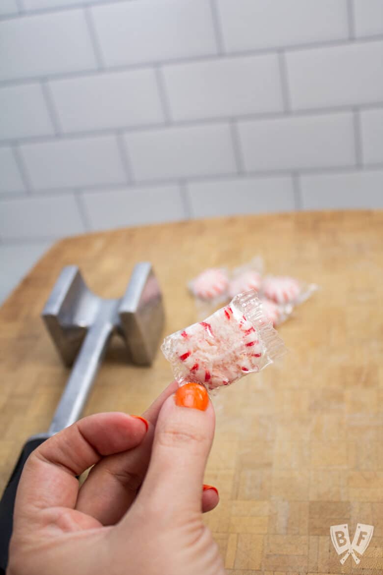 Holding up a crushed peppermint candy.