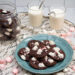 Milk and cookies surrounded by peppermints and mini marshmallows.