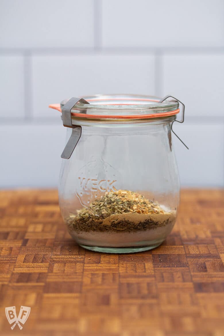 Jar with layered spices ready to be mixed together.