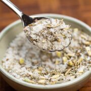 Bowl of dry brine seasoning mix with a spoon lifting some out.