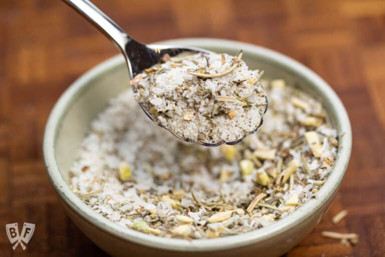 Bowl and spoon holding dry brine seasoning blend for turkey.