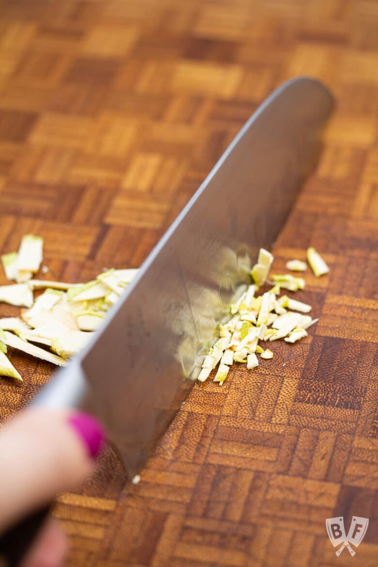 Chopping dehydrated apples with a knife.