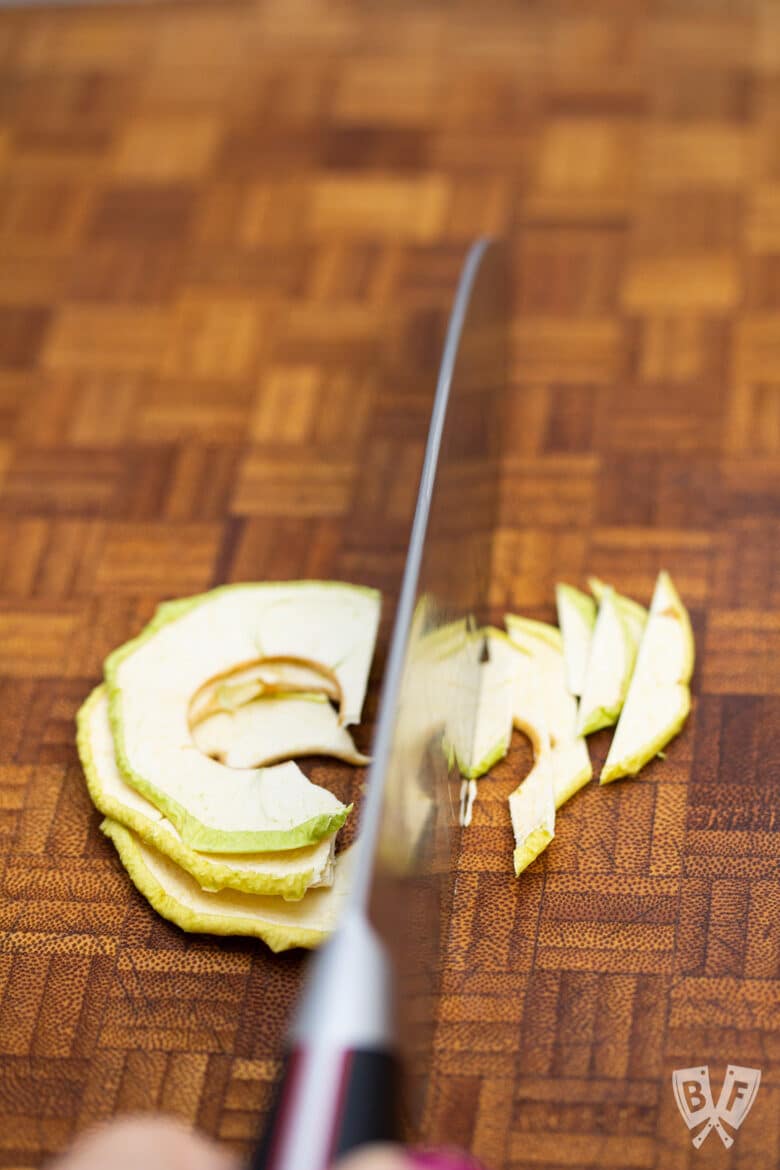 Cutting dehydrated apple rings.