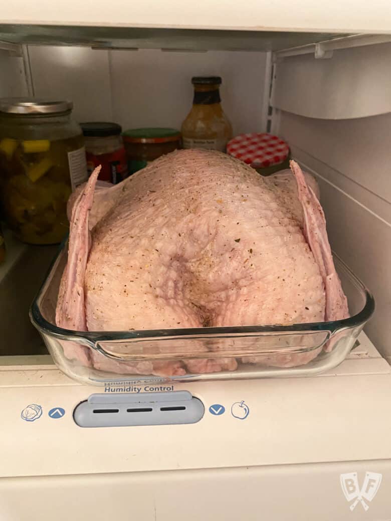 Turkey in the refrigerator with a dry brine mix applied to the skin.