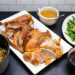 Sliced roast turkey on a platter surrounded by Thanksgiving side dishes.