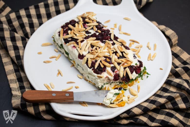 Gorgonzola fruit torta on a platter, topped with toasted slivered almonds.