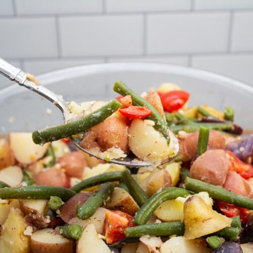Scooping a spoonful of Calabrese potato salad from the bowl