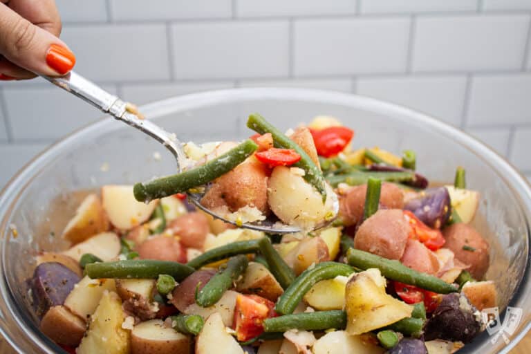 Scooping a spoonful of Calabrese potato salad from the bowl