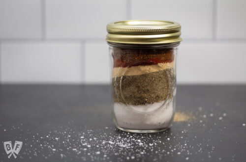 Glass jar filled with layers of spices.