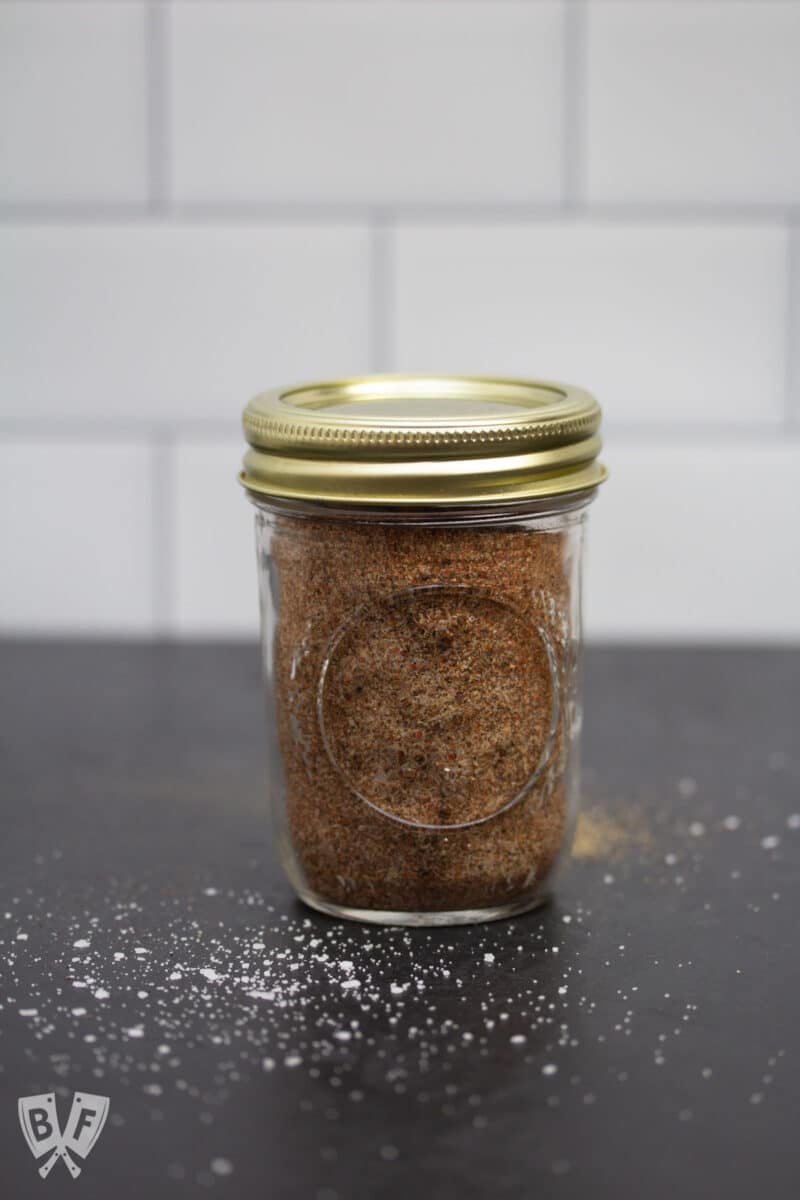 Glass jar filled with homemade grill seasoning.