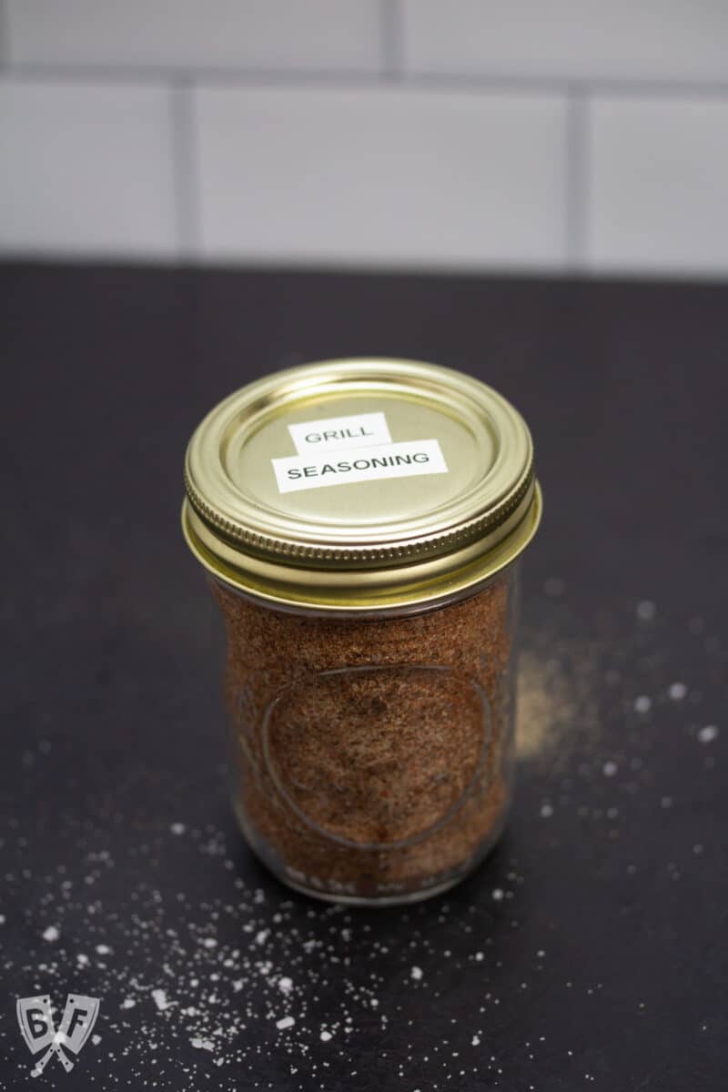 Glass jar full of spice mix labeled "grill seasoning".