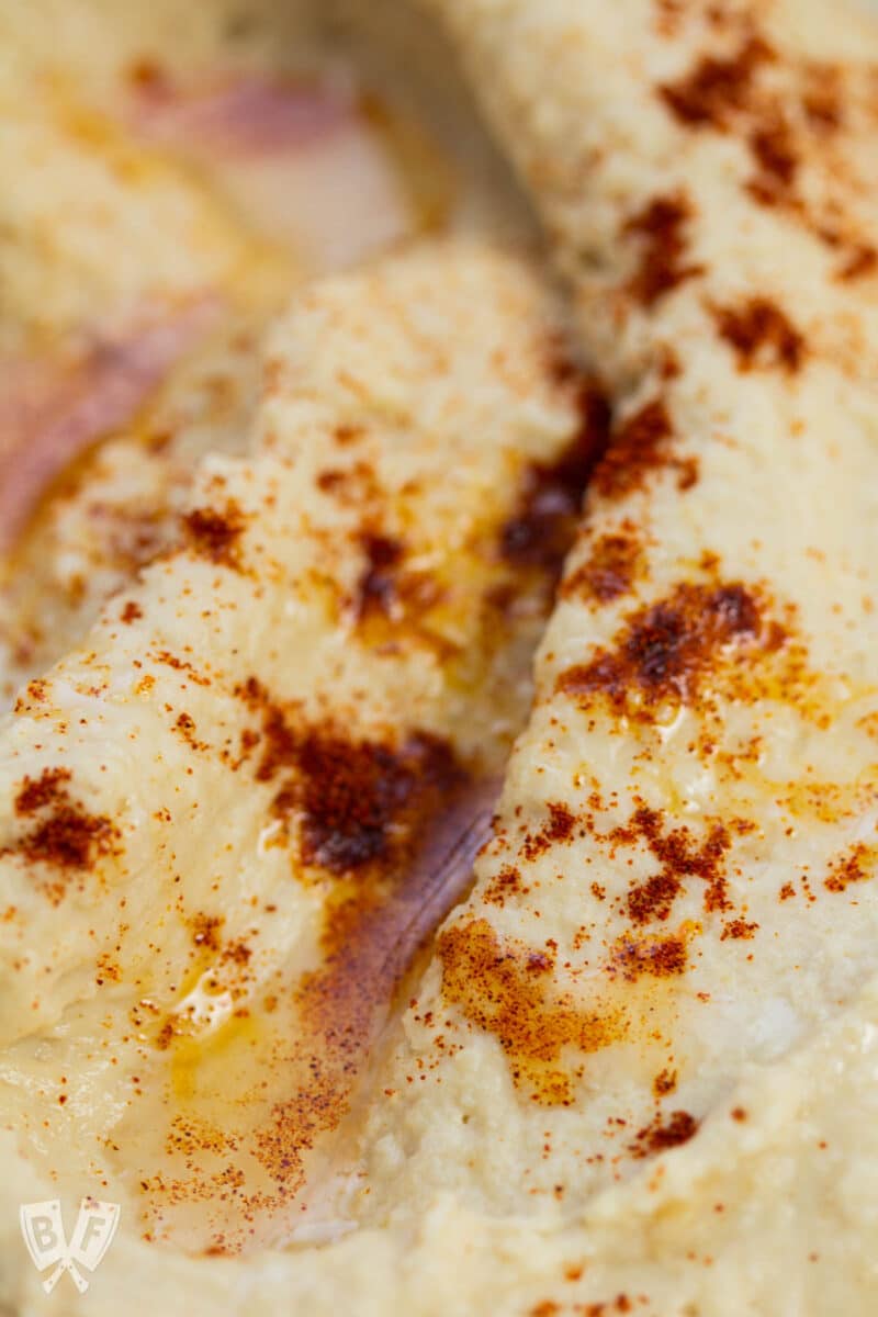 Close-up of hummus with paprika and olive oil.