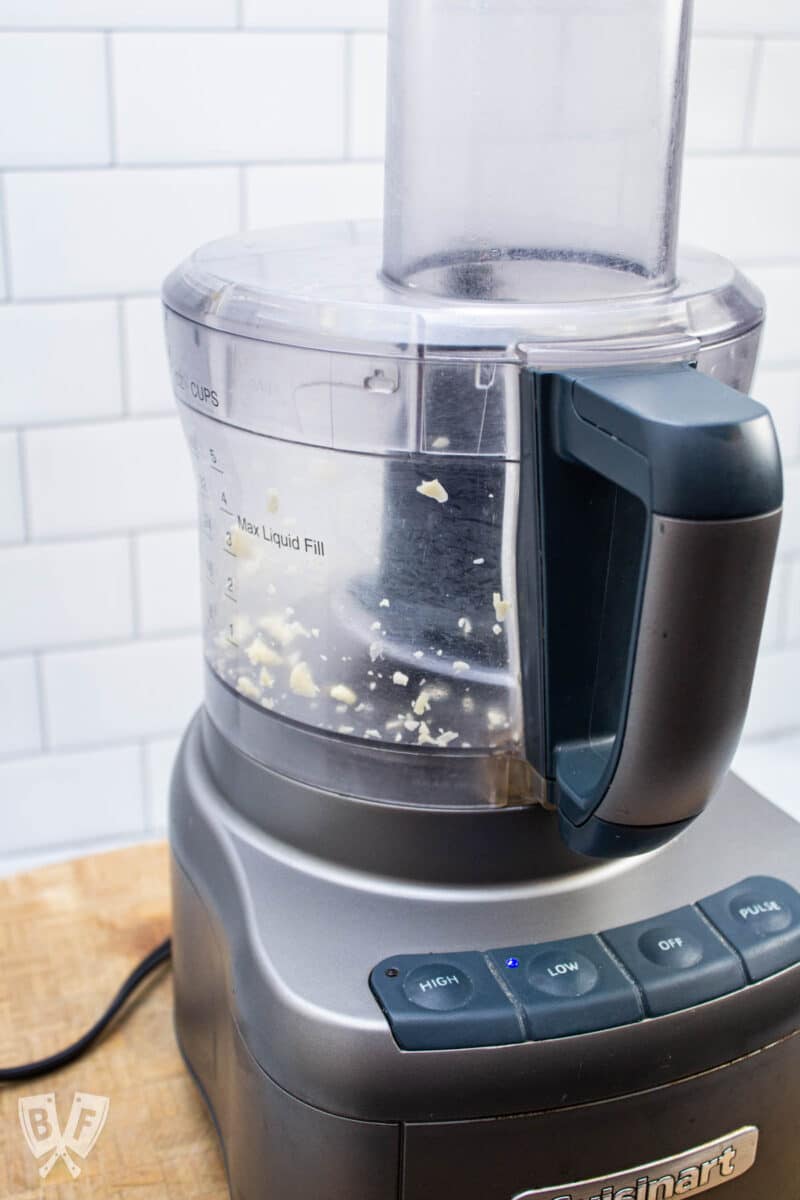 Food processor mincing garlic.