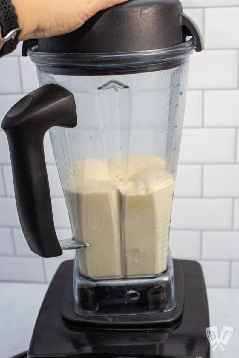 Blender mixing a peanut butter banana milkshake.