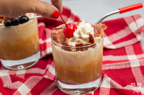 Placing a maraschino cherry on a peanut butter banana milkshake.