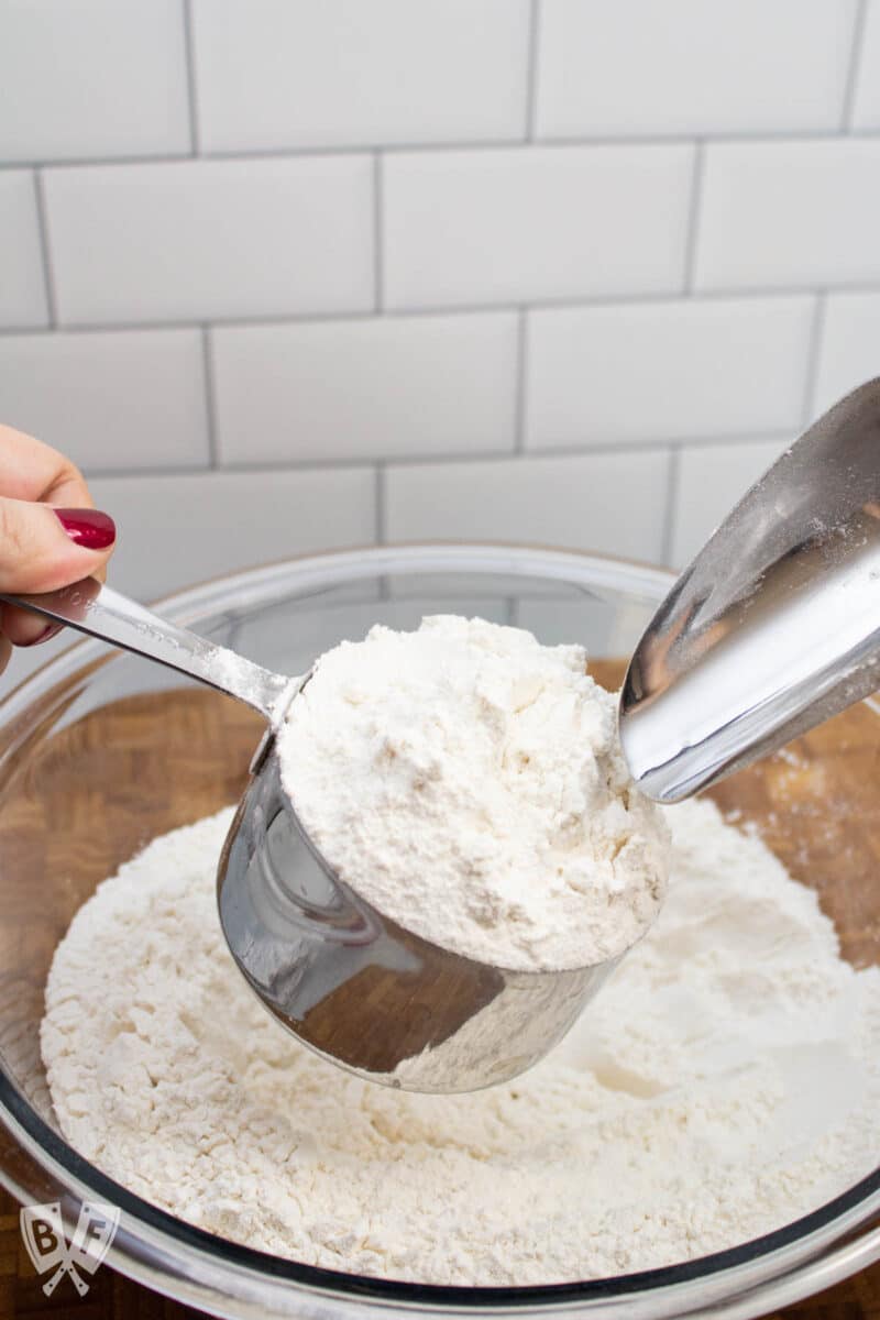 Pouring flour into a measuring cup.