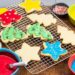 Cooling rack of decorated cut out sugar cookies.