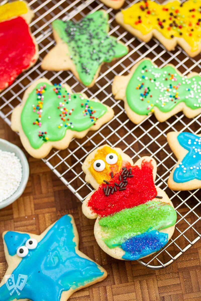 Cooling rack of decorated cut out sugar cookies.