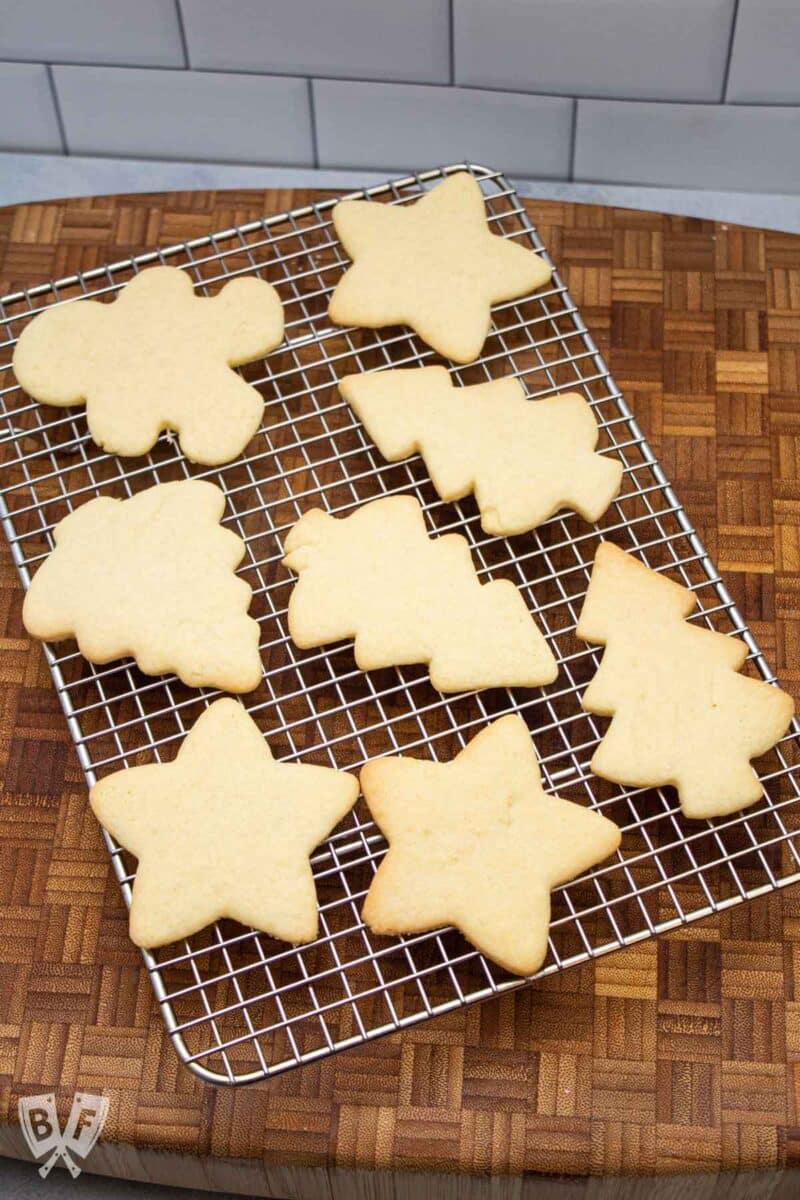 Christmas shaped cut out sugar cookies on a cooling rack.