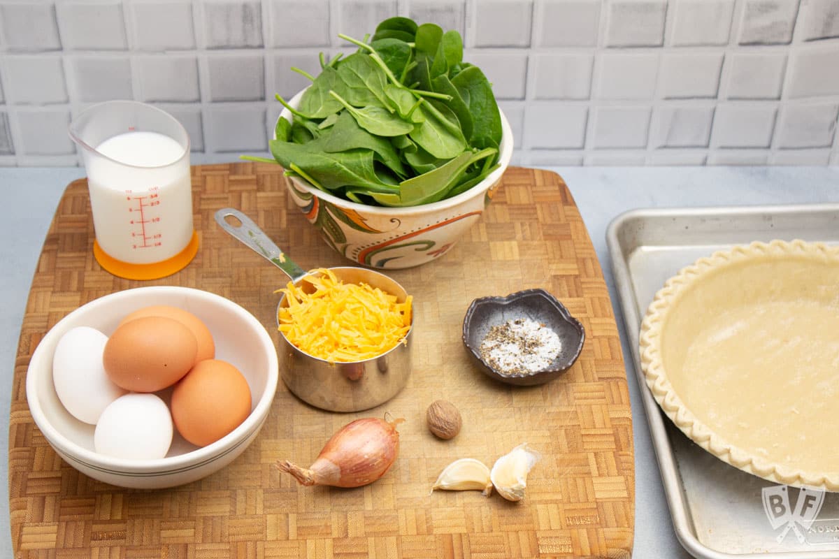 Ingredients ready to make a baby spinach and cheddar quiche.