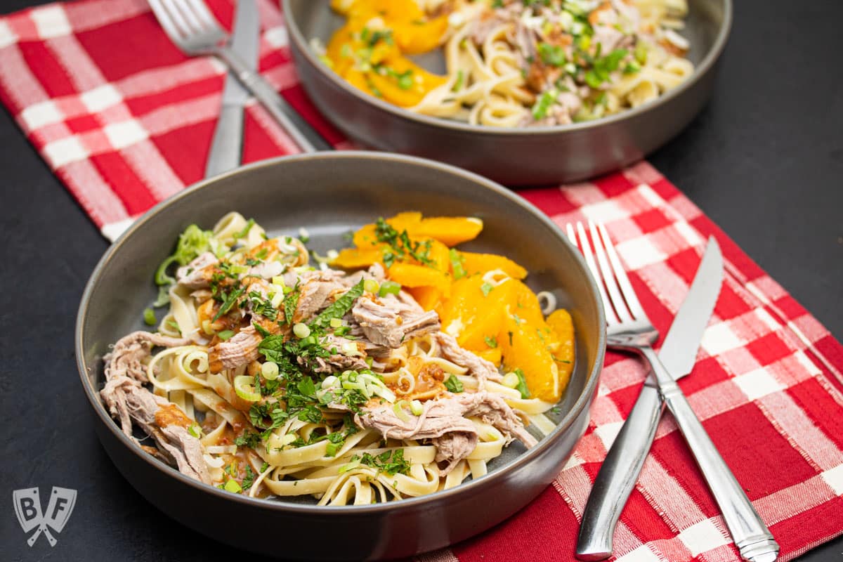 Peanut noodles with shredded pork, fresh herbs, and honeyed oranges.