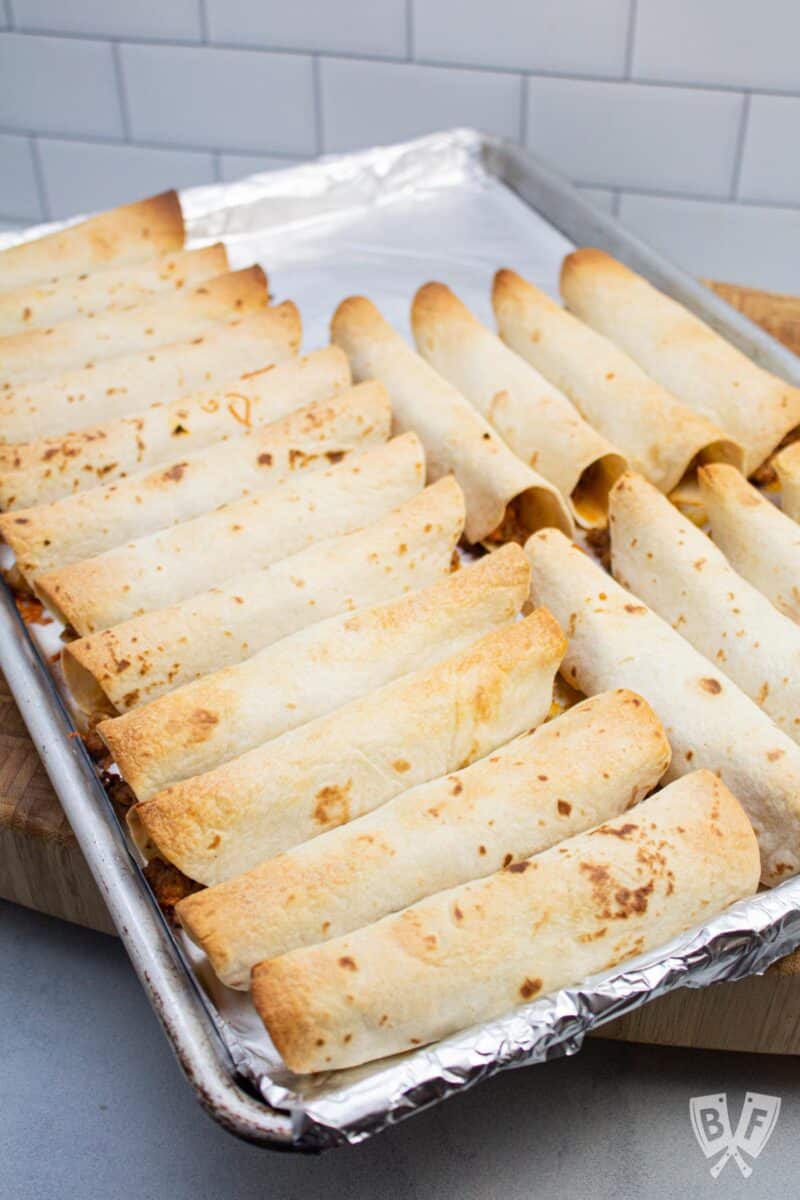 Sheet pan of taquitos fresh out of the oven.