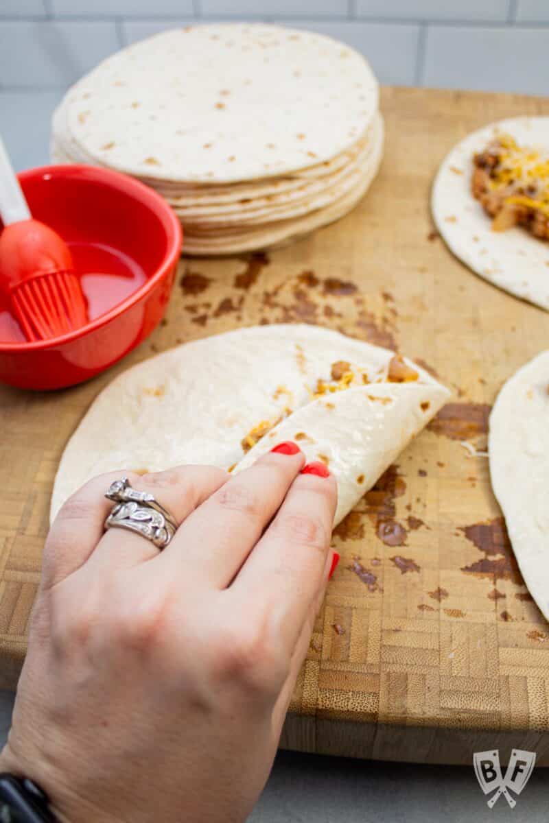 Rolling up taquitos to bake.