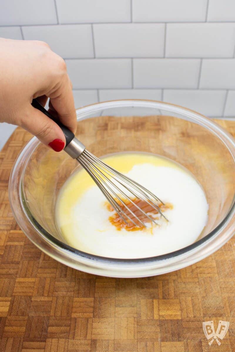 Whisking together the wet ingredients for funfetti pancakes.