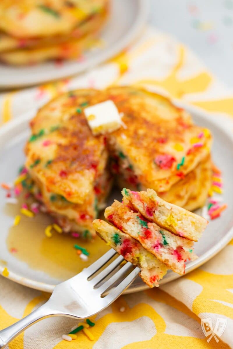 Close-up of a forkful of birthday cake confetti pancakes.