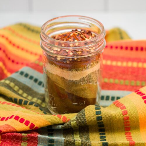 Glass jar of homemade taco seasoning mix.