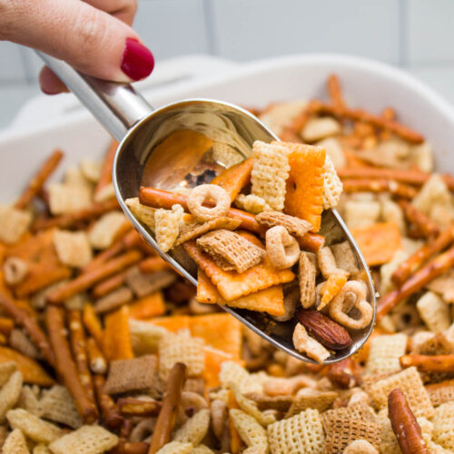 Scooping up a helping of homemade cereal snack mix.