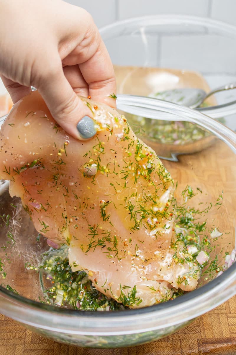 Coating chicken cutlets in a dill shallot marinade