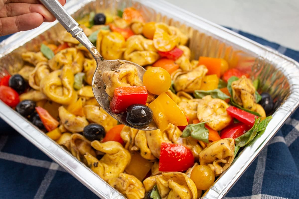 Grabbing a spoonful of pasta salad with creamy balsamic vinaigrette.