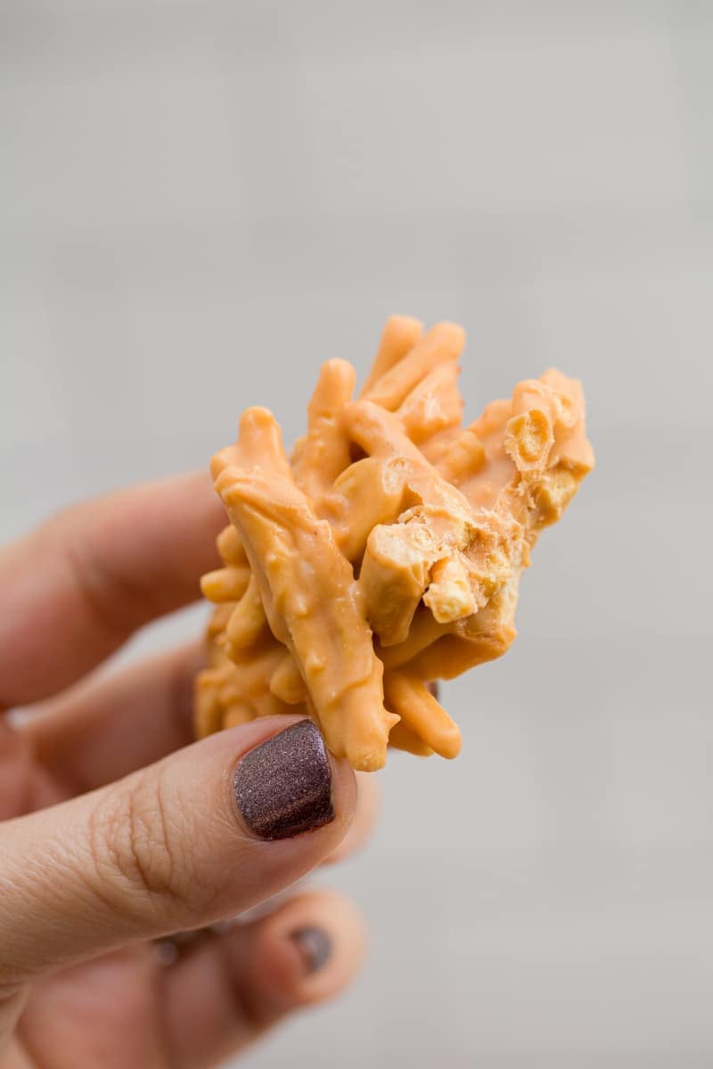 Hand holding a clustered no-bake butterscotch haystack.