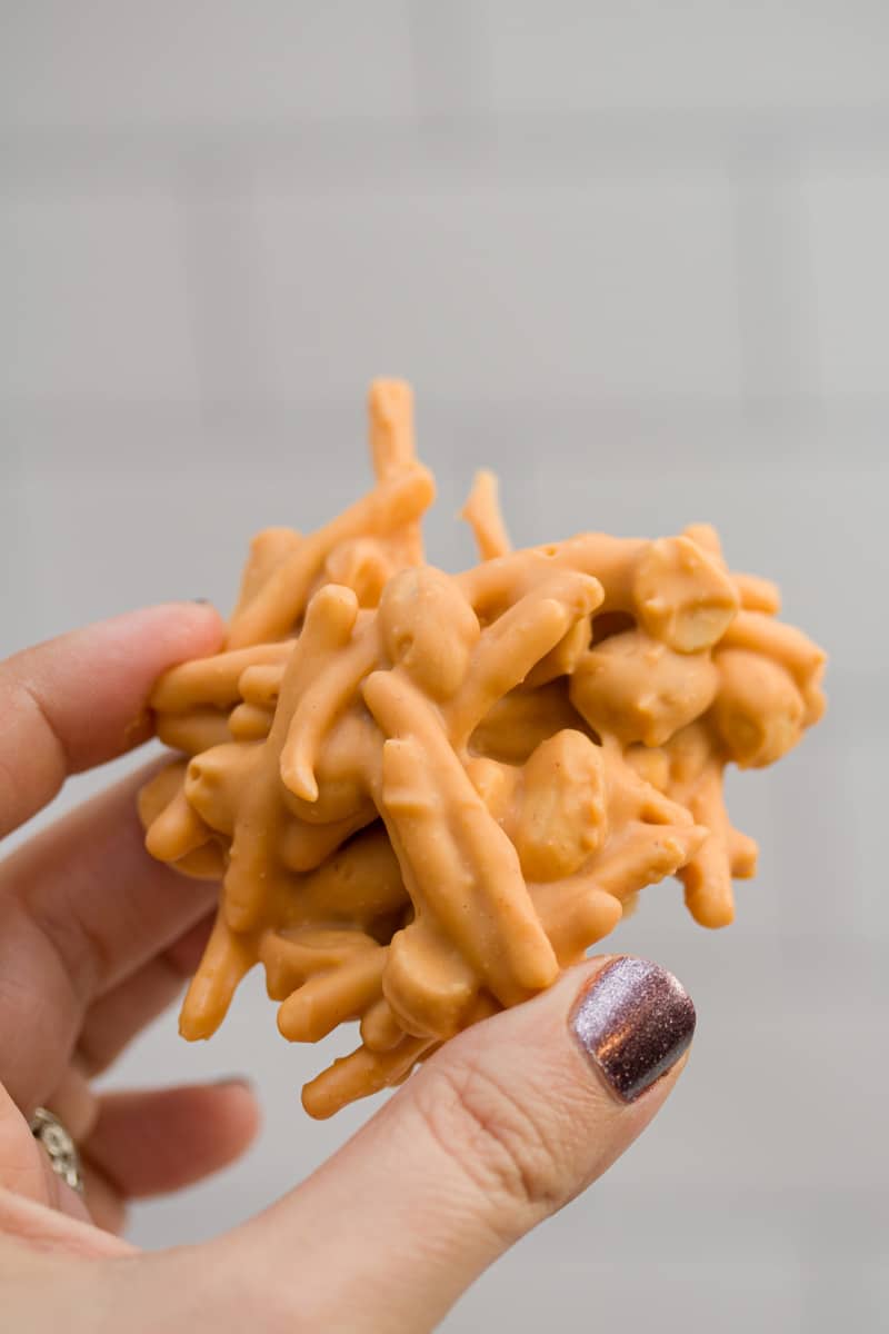 Hand holding a clustered no-bake butterscotch haystack.