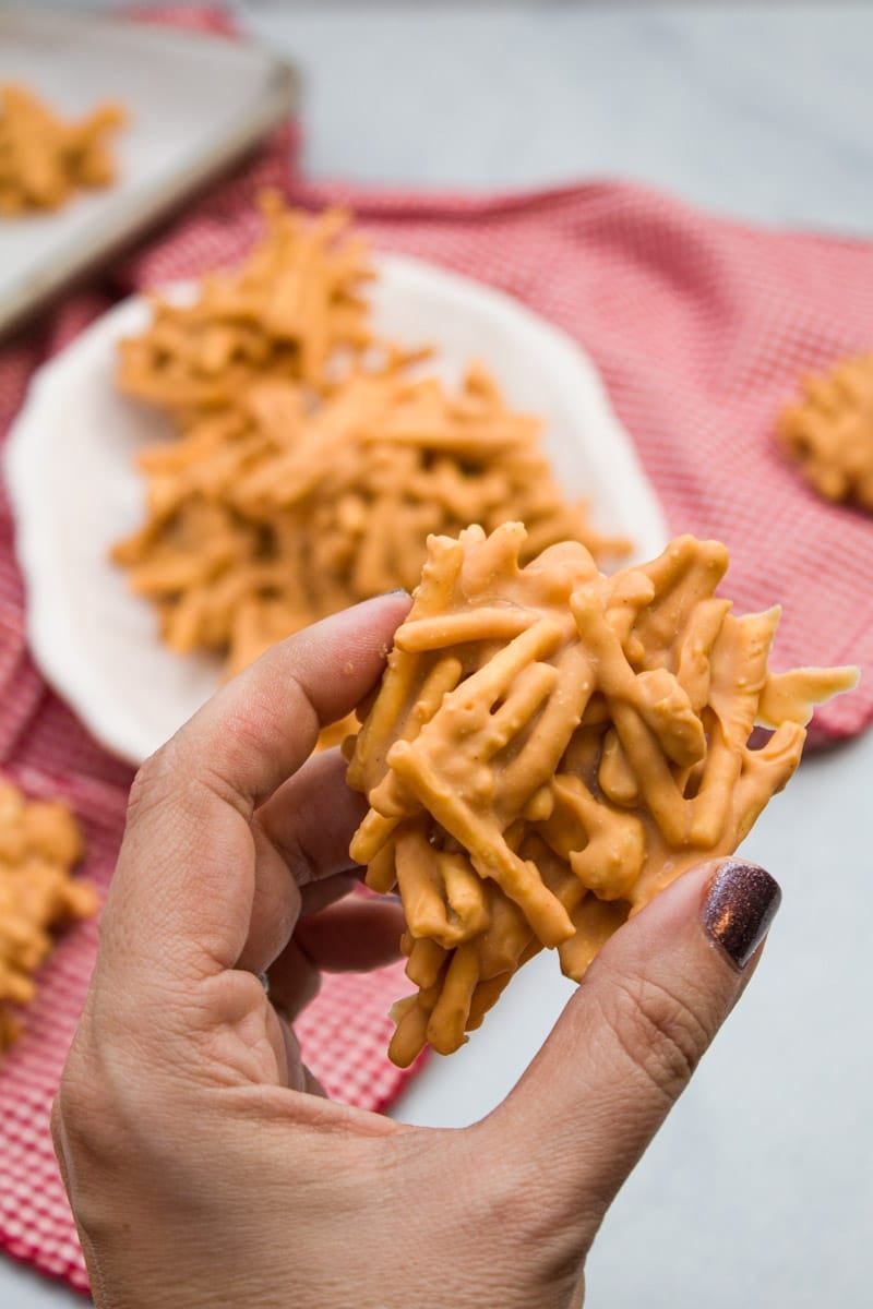 Hand holding a clustered no-bake butterscotch haystack.