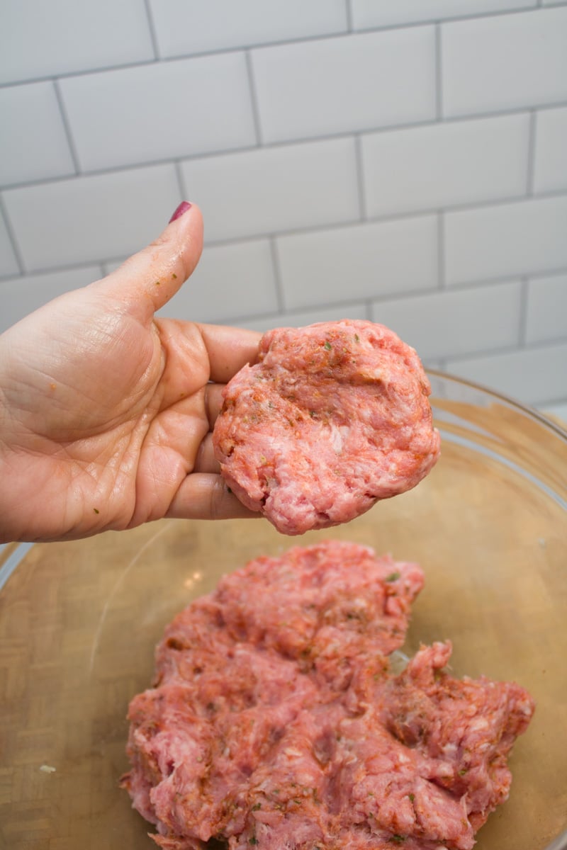 Forming a ground pork mixture into breakfast sausage patties.
