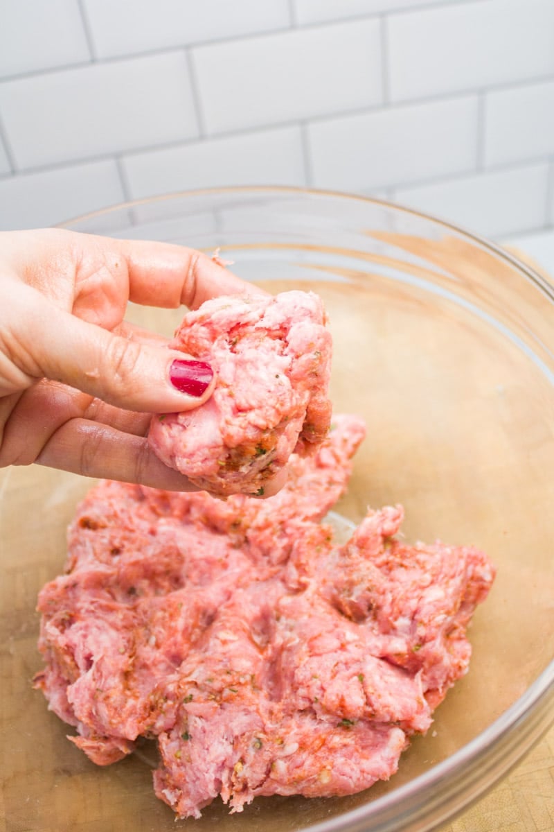 Dividing ground pork mixture to make breakfast sausage patties.