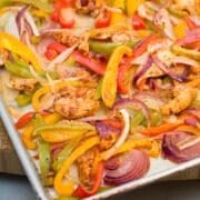Sheet pan of cooked chicken fajita mixture.