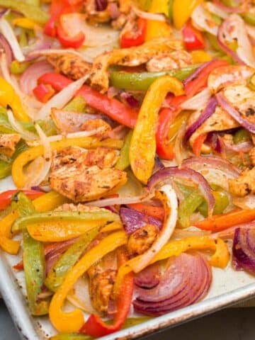 Sheet pan of cooked chicken fajita mixture.