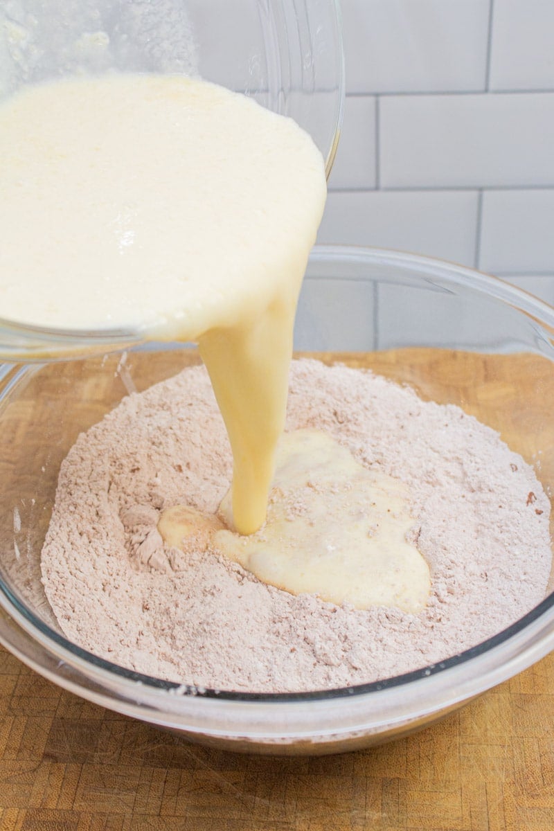 Adding wet ingredients to dry ingredient for chocolate chocolate chip pancakes.