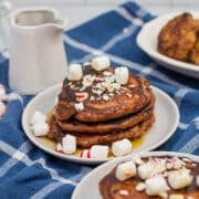 Stack of chocolate chocolate chip pancakes with peppermints and mini marshmallows.